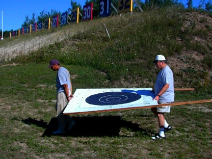 Fazal and Jim caryring large frame to the pits